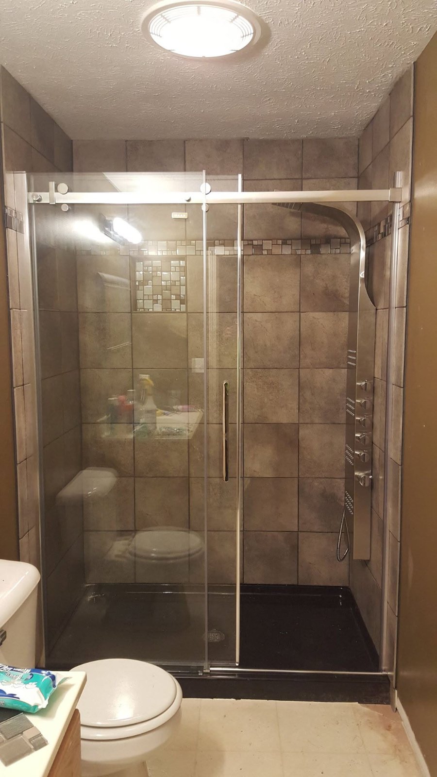 New base, ceramic tile walls, sliding glass door, and rainmaker